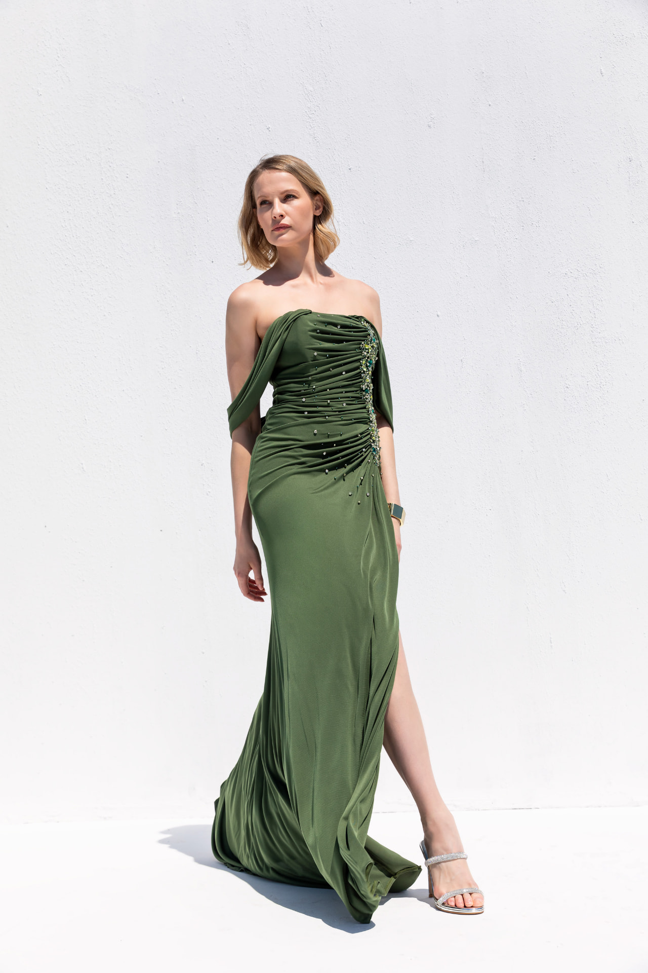 Olive green off-shoulder gown with crystal-beaded ruched bodice and high slit
