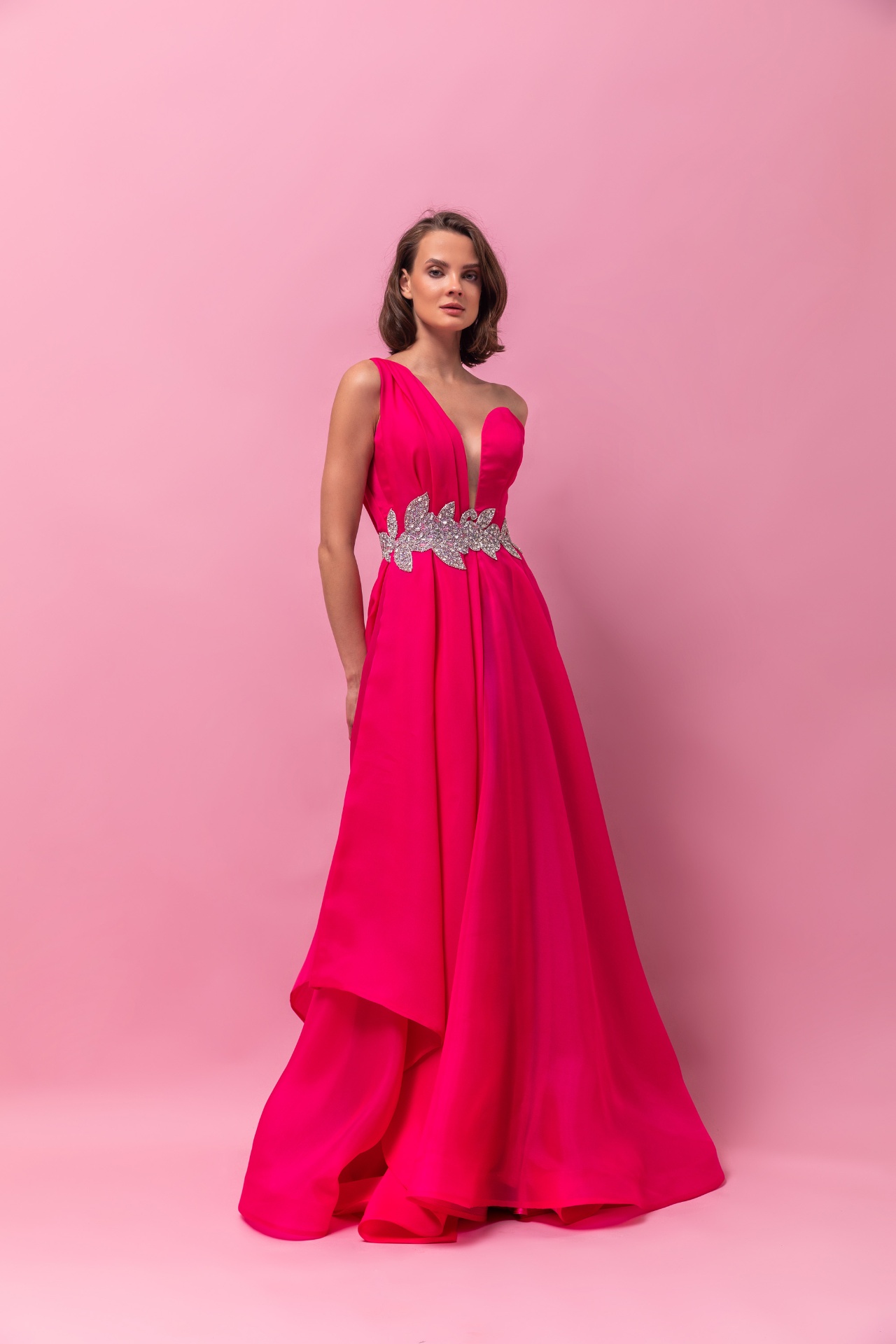 Fuchsia one-shoulder satin gown with crystal leaf belt and high-low skirt