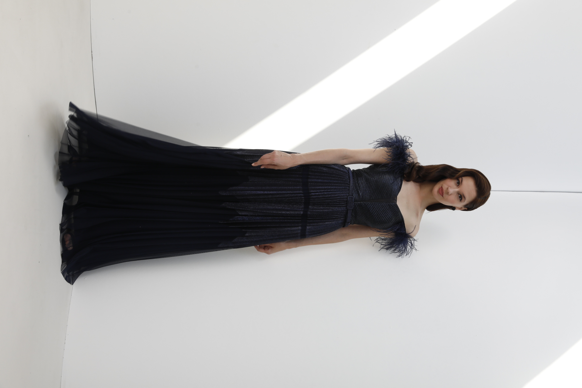 Navy off-shoulder feather-trimmed metallic gown with pleated tulle skirt