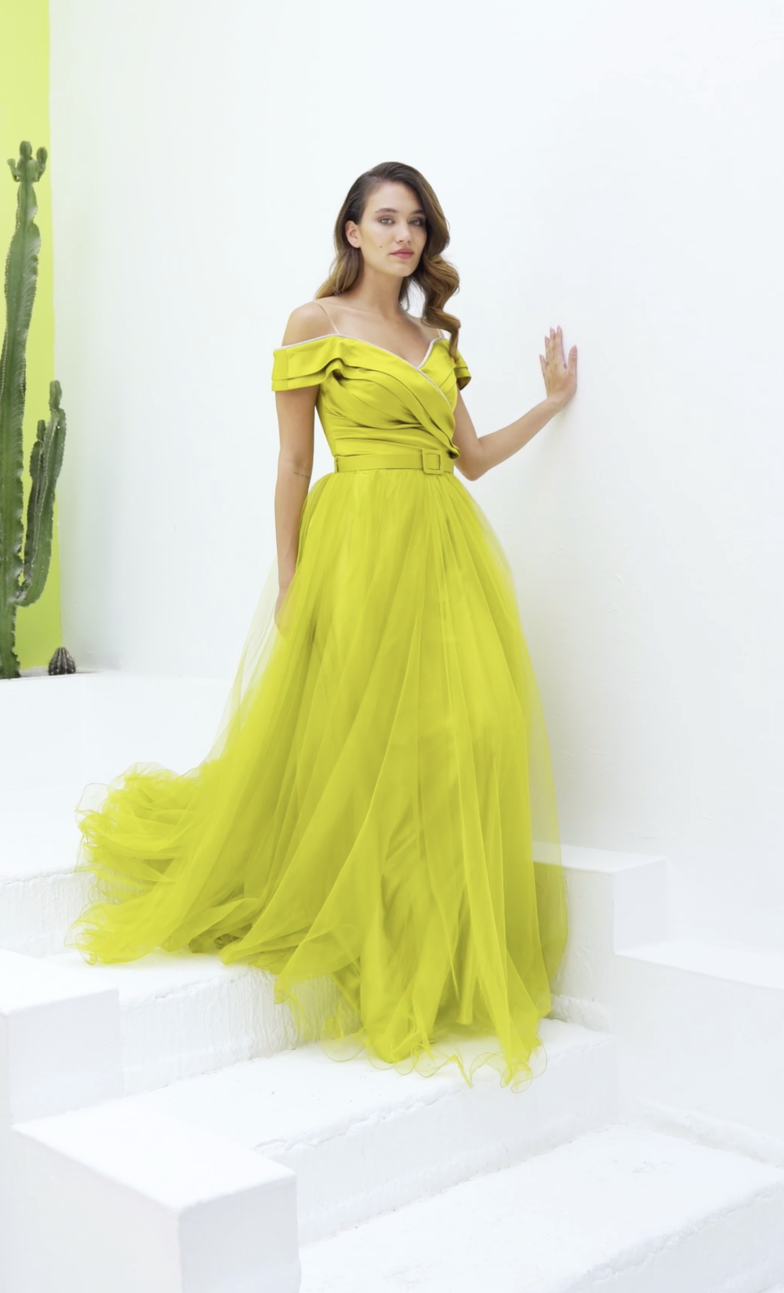 Chartreuse off-shoulder tulle ball gown with belted waist and flowing train