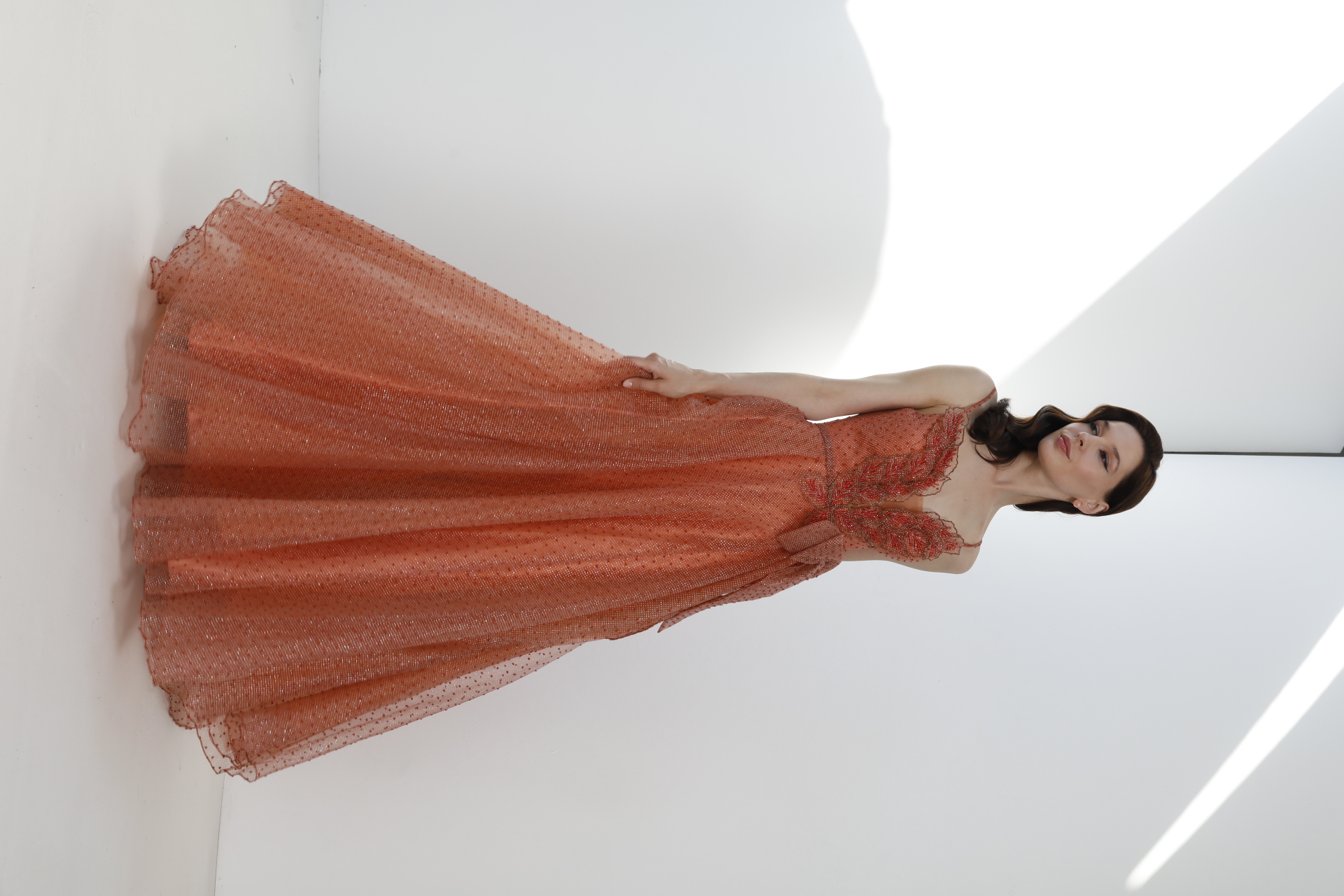 Coral glitter tulle A-line ball gown with beaded leaf bodice and bow