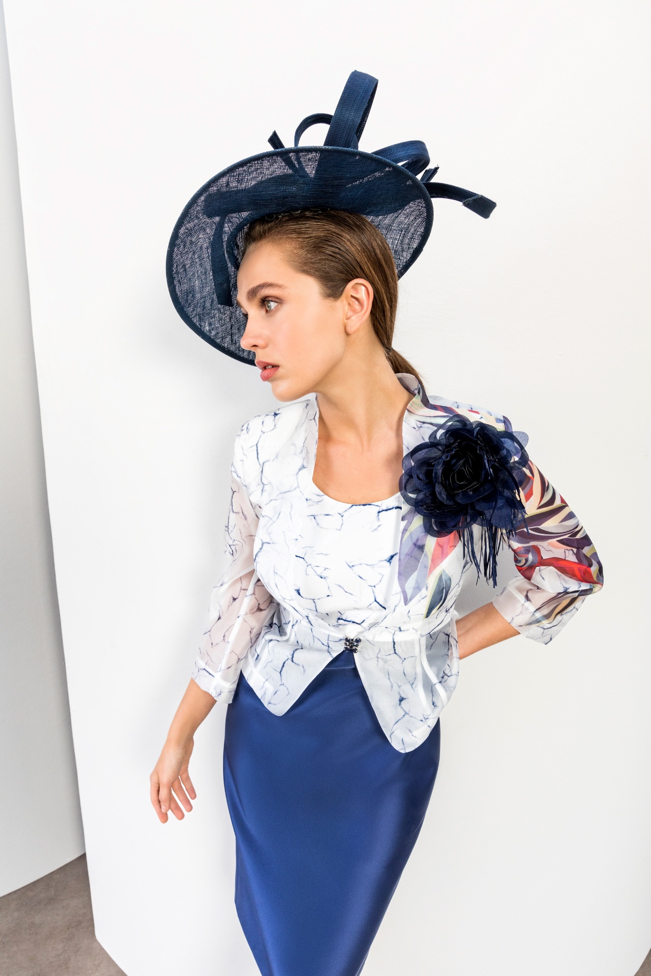 Ivory marbled print peplum jacket with cobalt pencil skirt and navy fascinator