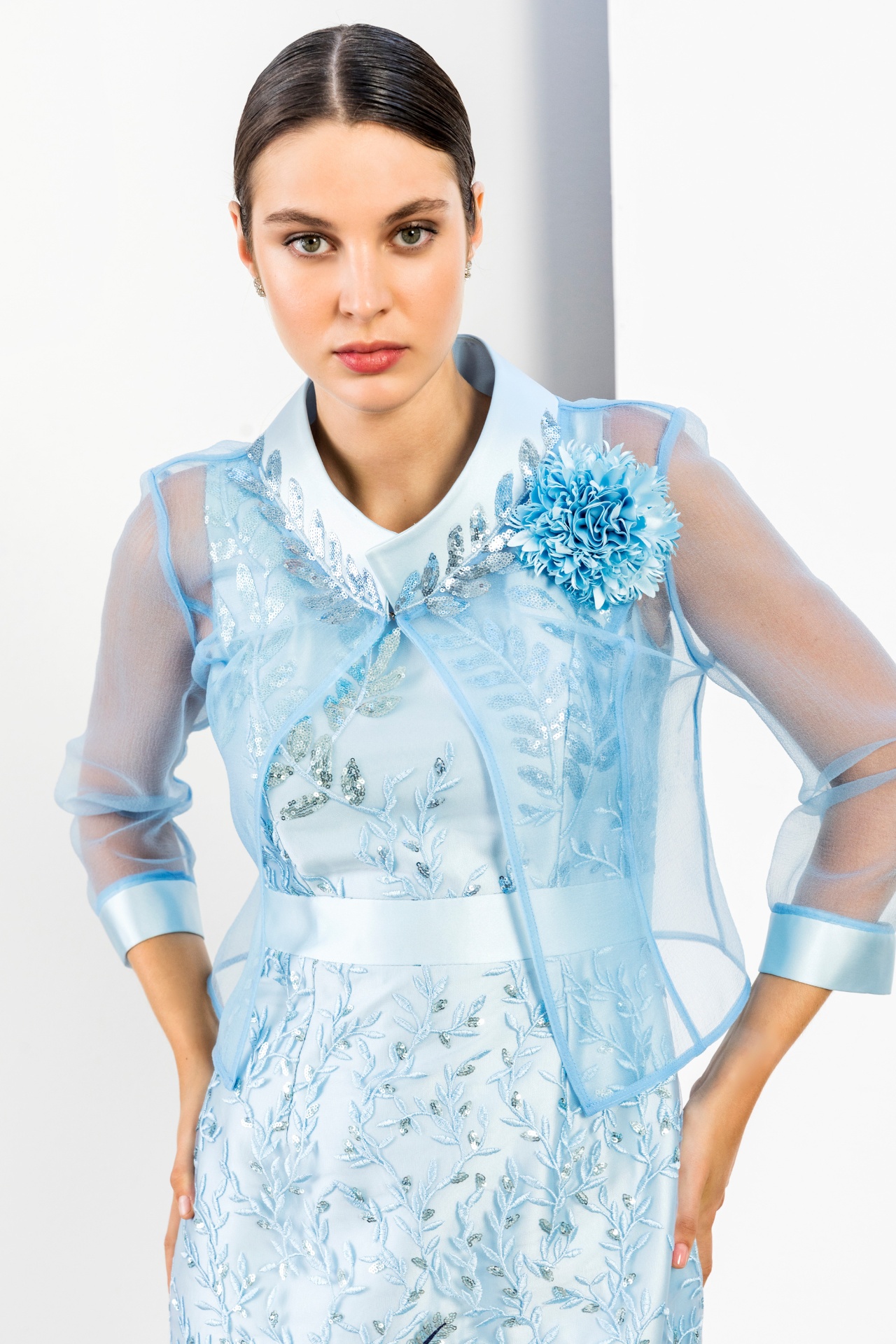Powder blue sheer organza jacket with sequin leaf embroidery and floral corsage