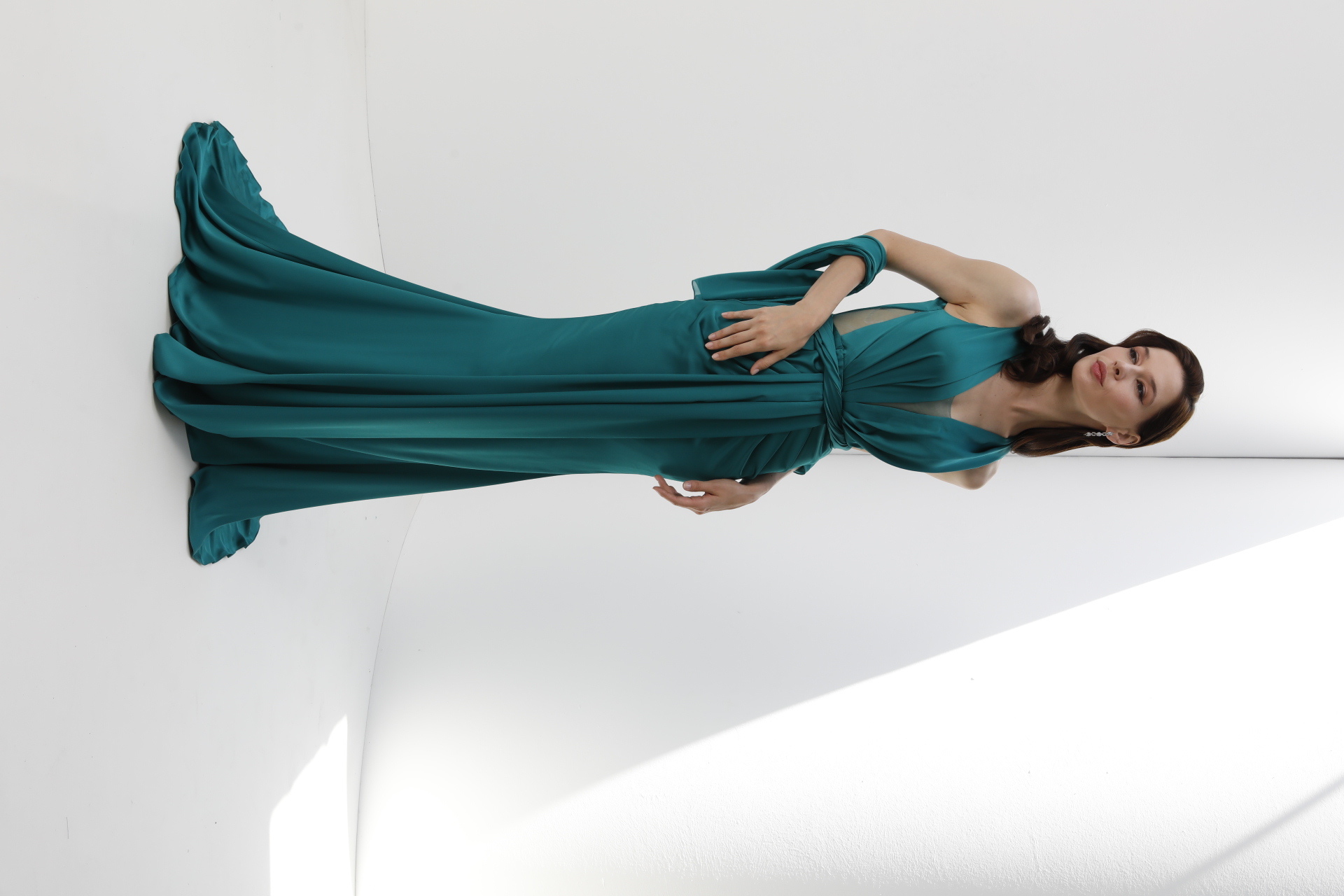 Teal satin plunge gown with draped waist, open sides and sweeping train