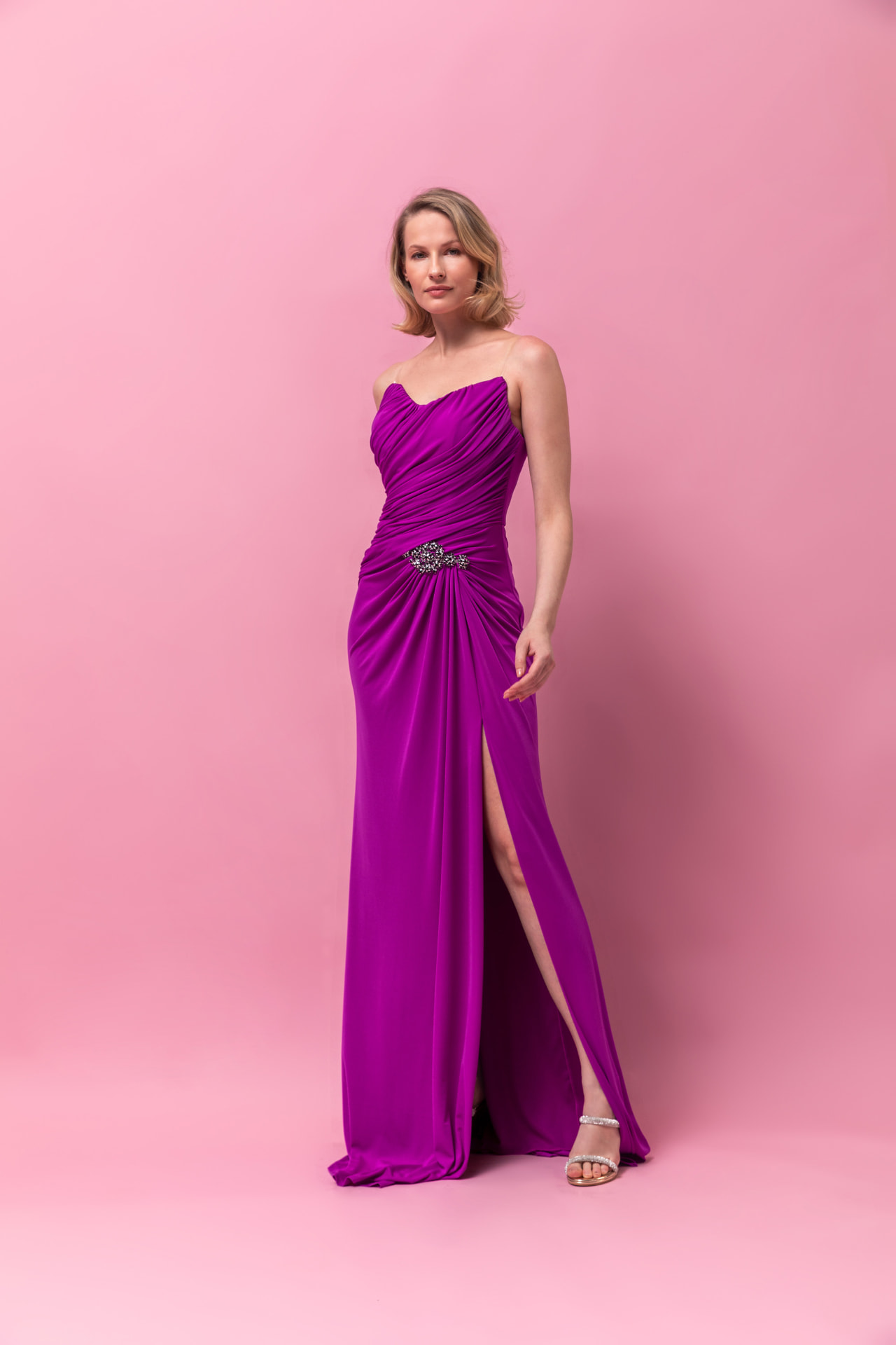 Magenta strapless ruched jersey gown with crystal waist ornament and high slit