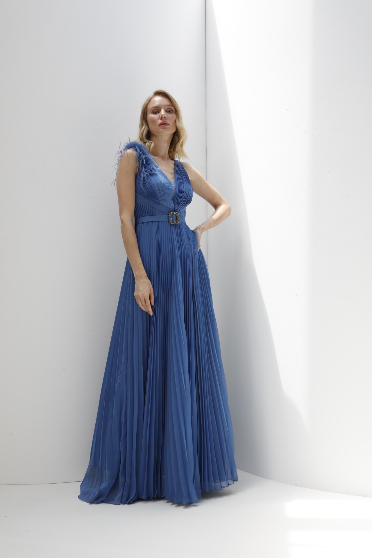 Cobalt pleated chiffon gown with feather shoulder