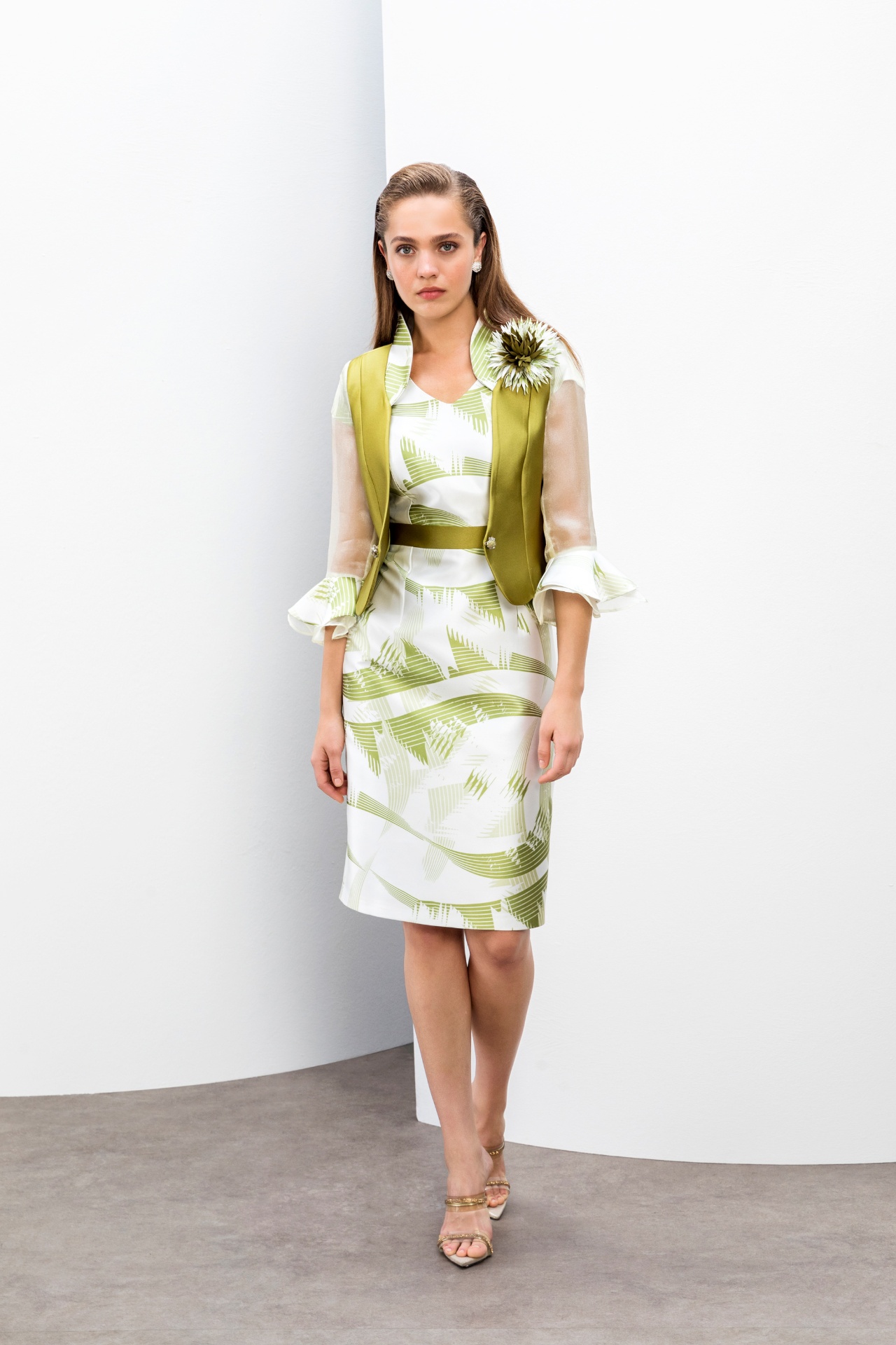 Olive green organza bolero over ivory and green fern-print sheath dress
