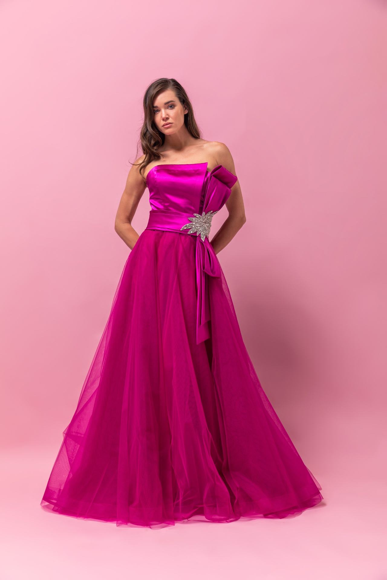 Magenta strapless satin and tulle ball gown with crystal starburst bow